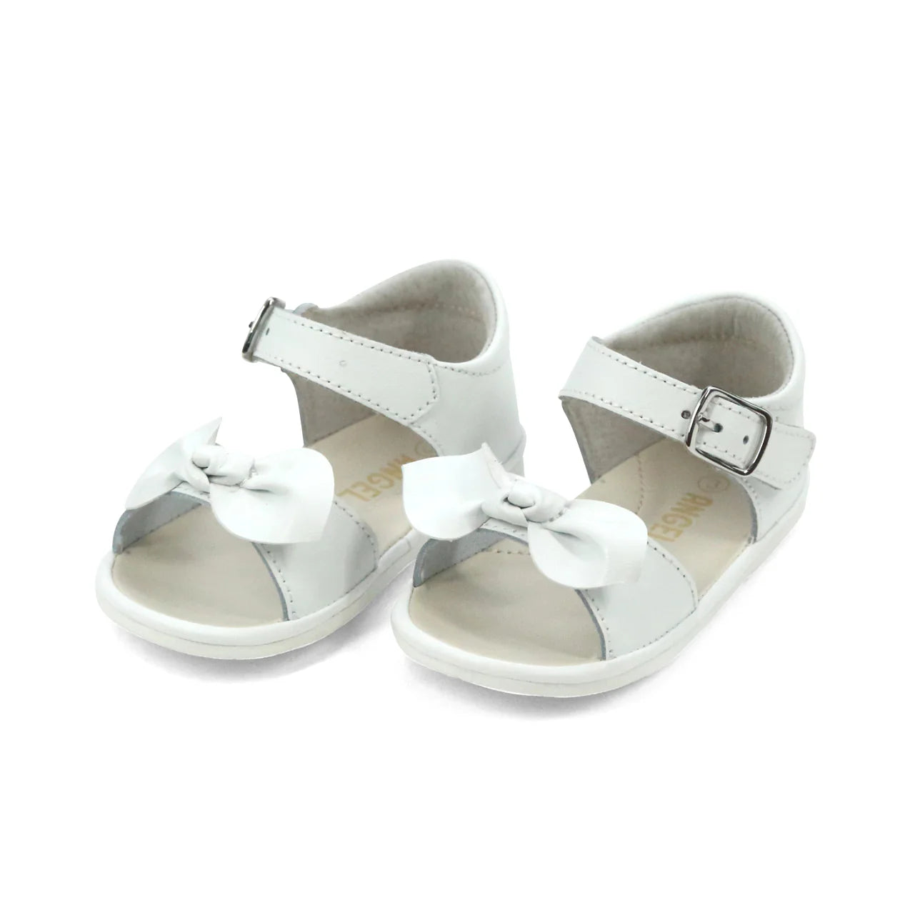 White children's sandals with bow details on a white background
