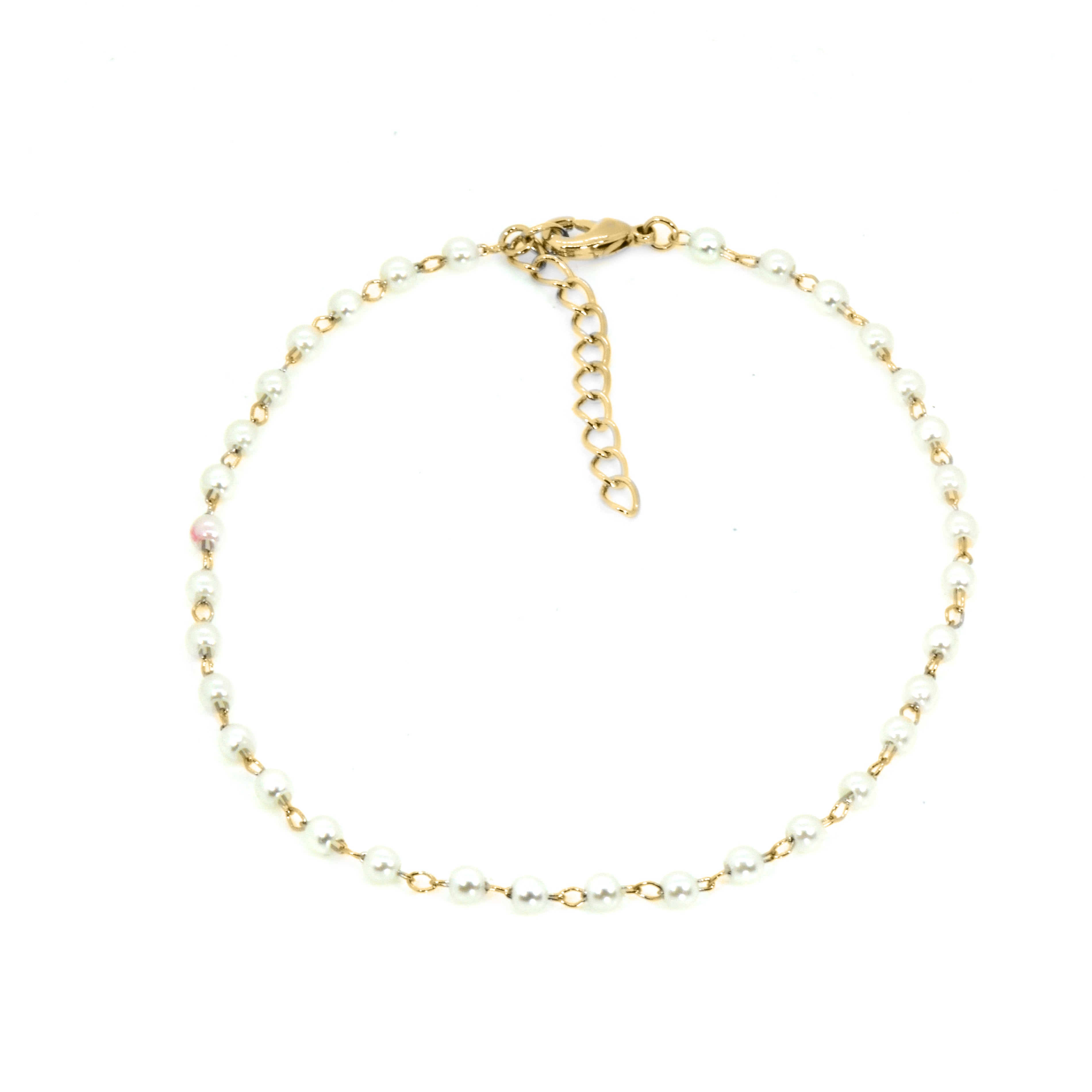 Gold anklet with small beads on a white background