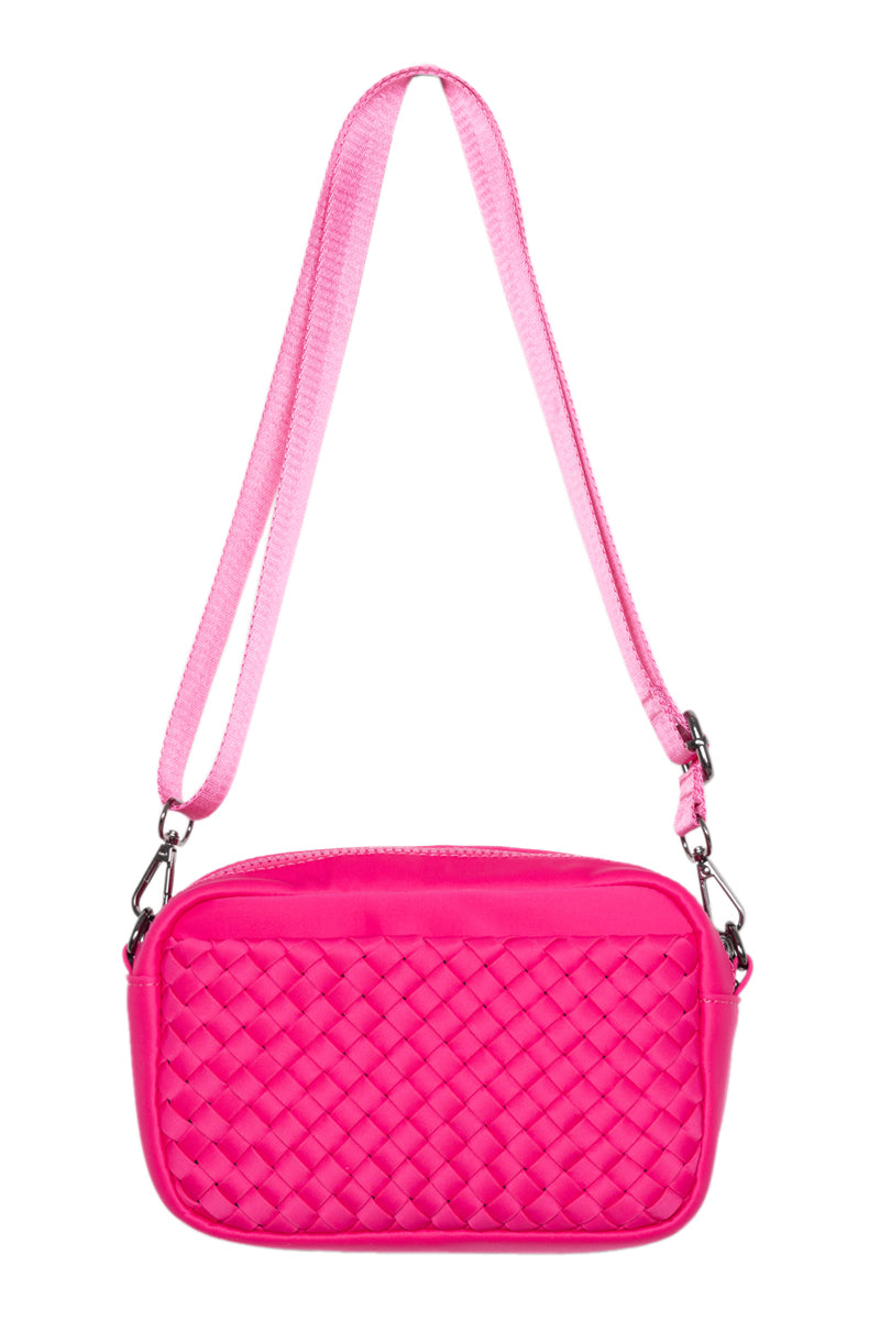 Pink quilted handbag with a strap on a white background