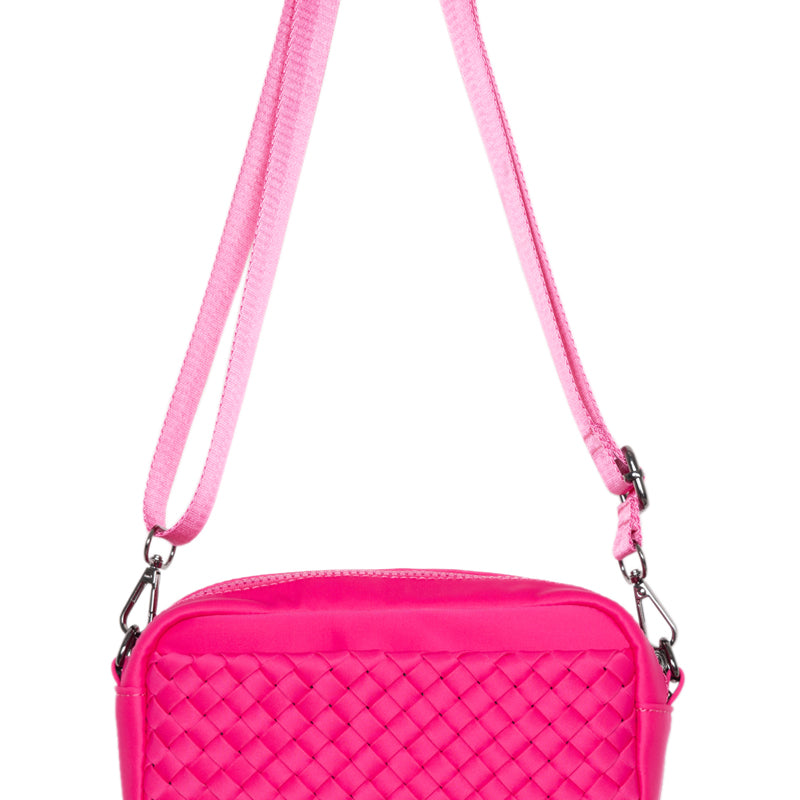 Pink quilted handbag with a strap on a white background