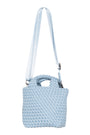 Light blue textured handbag with a strap on a white background