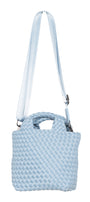 Light blue textured handbag with a strap on a white background