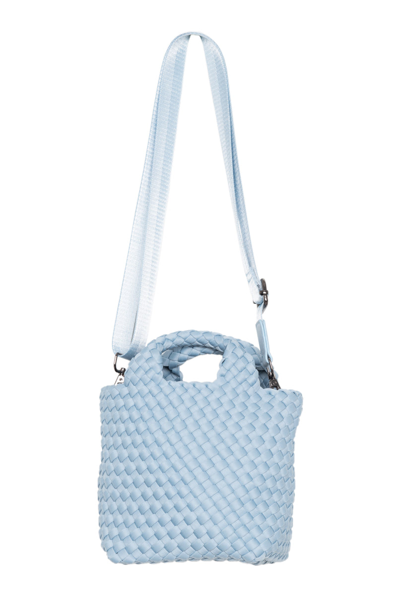 Light blue textured handbag with a strap on a white background