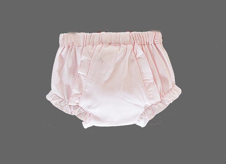 A pair of light pink baby bloomers with a gathered elastic waistband and ruffled trim, shown against a solid gray background.