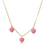Gold necklace with pink heart-shaped pendants on a white background
