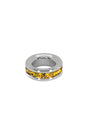 Silver ring with yellow gemstones on a white background