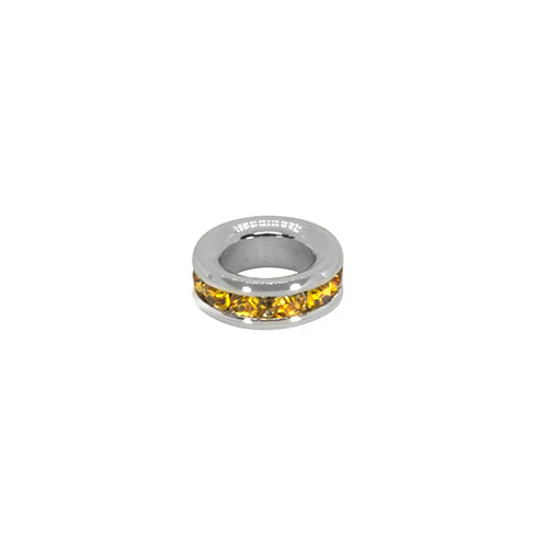 Silver ring with yellow gemstones on a white background
