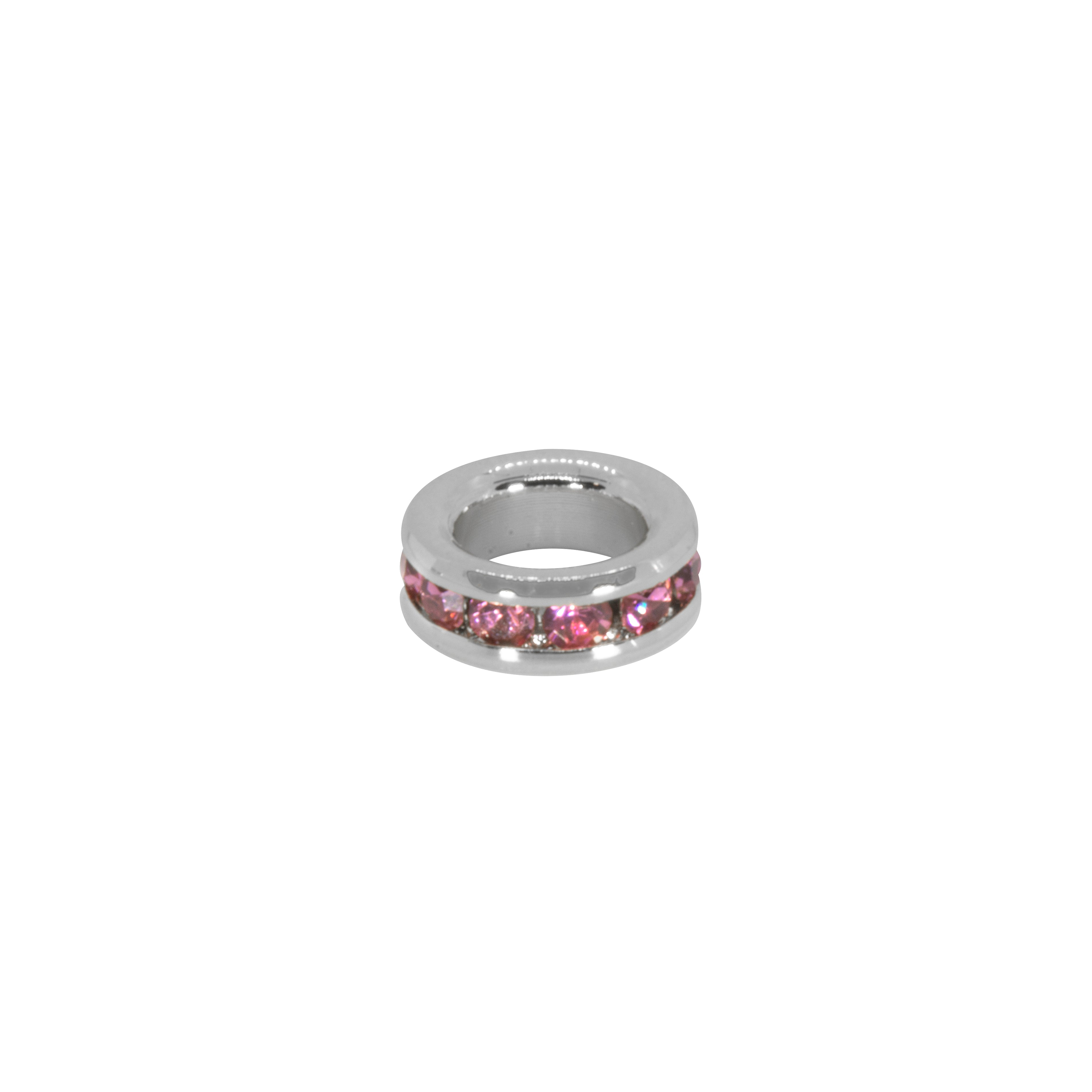 Silver ring with pink gemstones on a white background