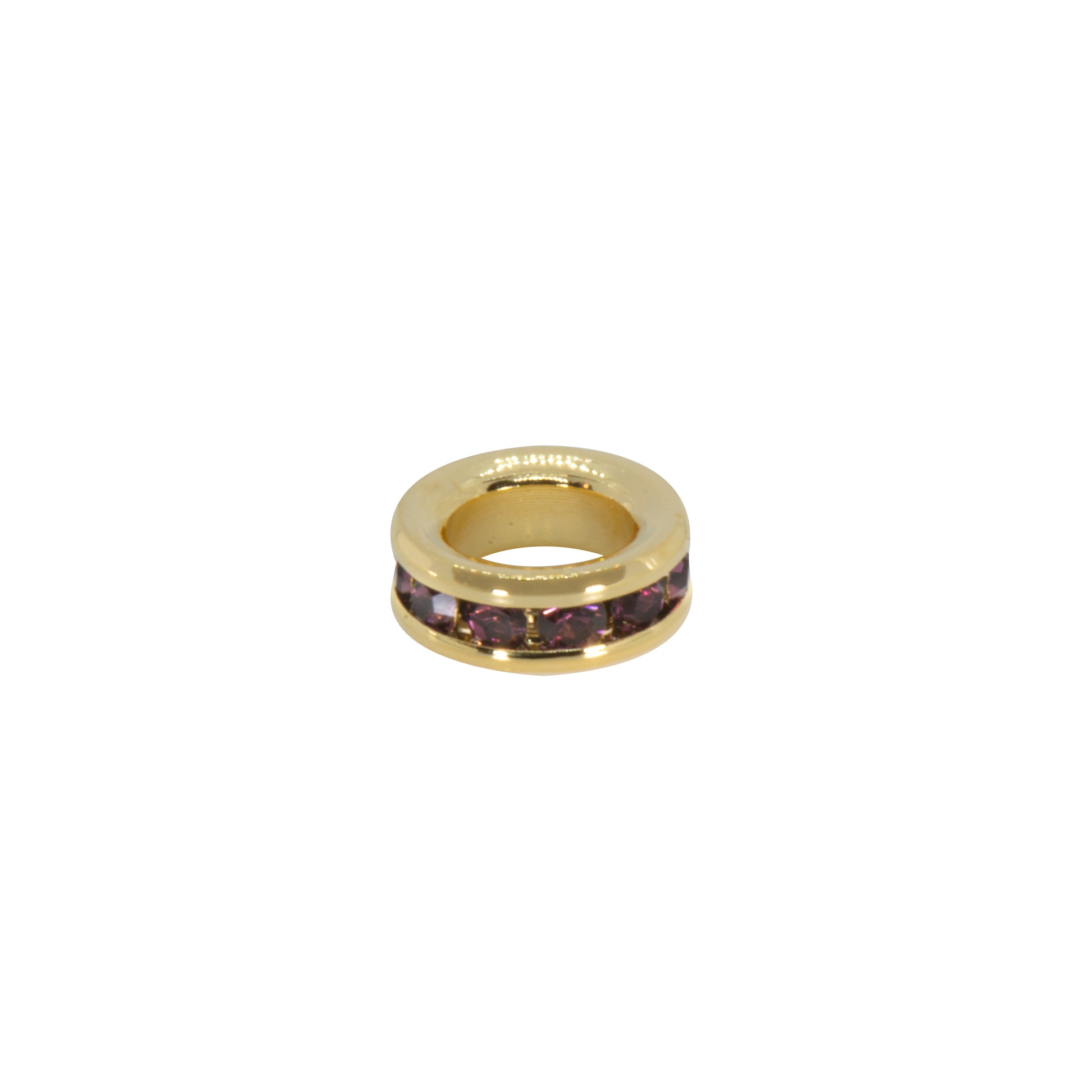 Gold ring with purple stones on a white background