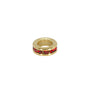 Gold charm with red gemstones on a white background