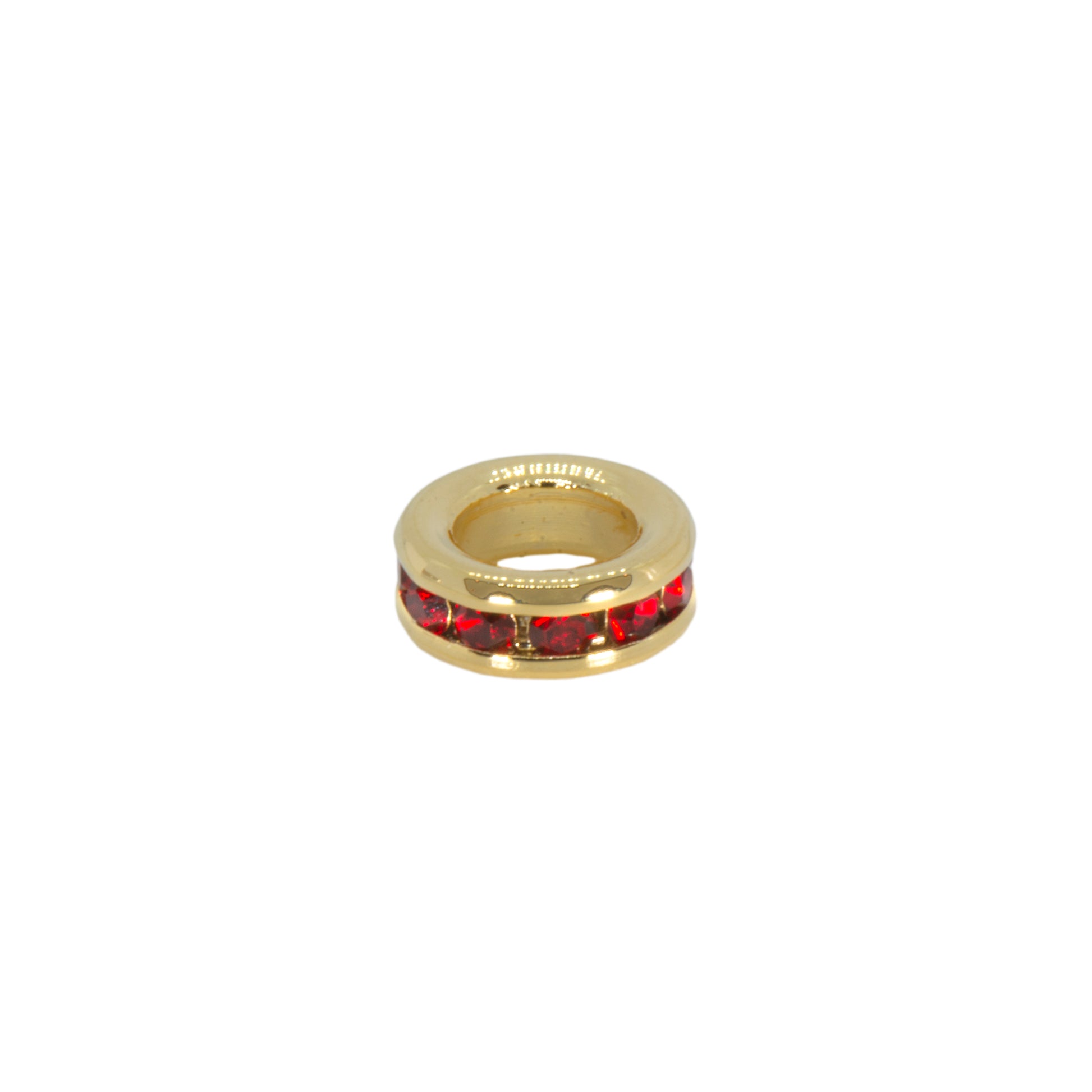 Gold charm with red gemstones on a white background