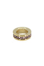 Gold ring with embedded stones on a white background