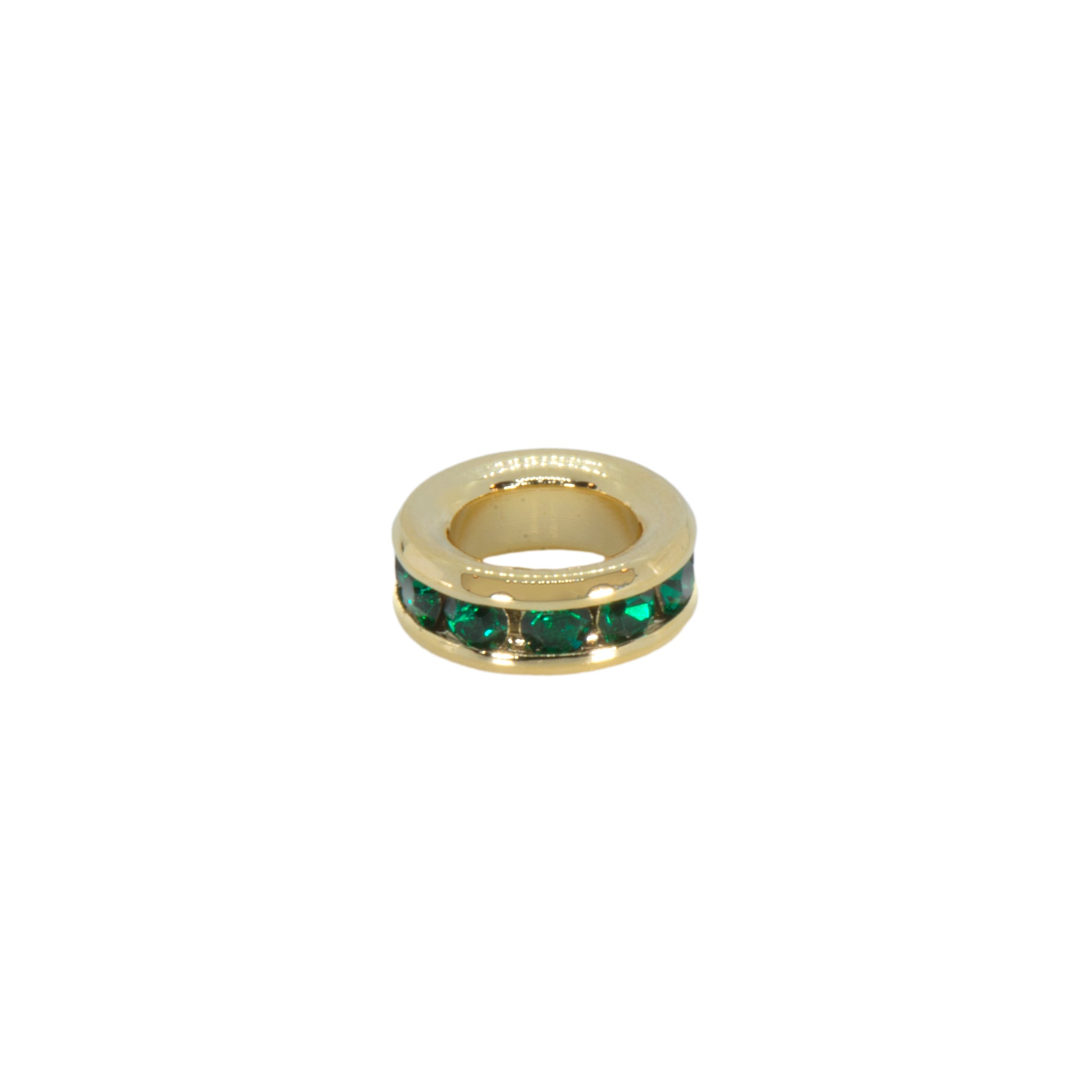 Gold ring with green gemstones on a white background