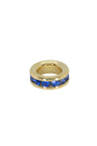 Gold ring with blue stones on a white background