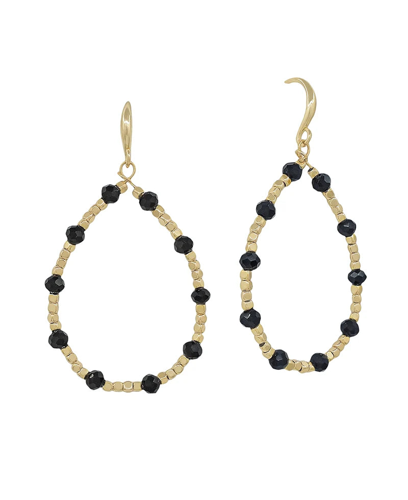 A pair of gold-tone teardrop dangle earrings with faceted black beads spaced along the open oval frame, shown on a plain white background.