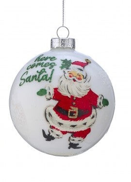 Glass ball ornament with dancing Santa and 'Here comes Santa' text in green
