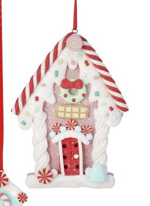 A gingerbread house Christmas ornament with red and white striped roof, a red door, candy cane details, and a hanging red ribbon on a white background.