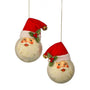 Two round Christmas ornaments shaped like Santa's face, each wearing a red Santa hat with white trim, green holly leaves, red berries, and a small gold bell, shown against a plain white background.