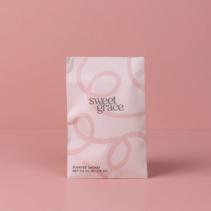 Sweet Grace scented sachet packaging on a pink background