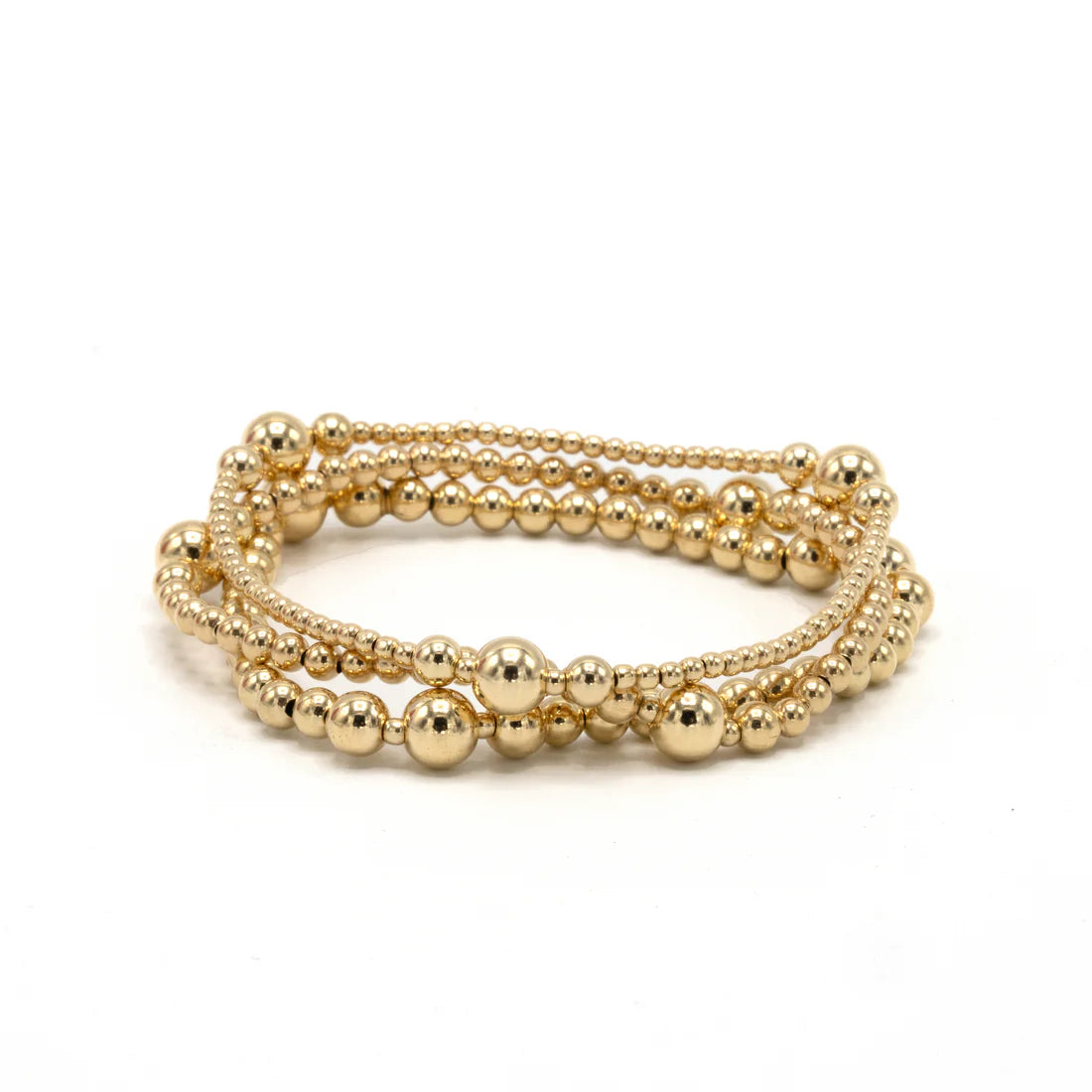 Gold beaded bracelet on a white background