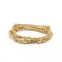 Gold beaded bracelet on a white background