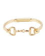 A gold-tone metal bracelet featuring a textured band, a coiled spring detail on one side, and two horsebit-style D-rings connected by a small central link, shown on a plain white background.
