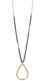 A long gold-tone necklace featuring a beaded strand with alternating sections of small black beads and gold spacer beads, culminating in a large open teardrop pendant.