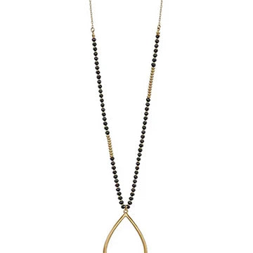A long gold-tone necklace featuring a beaded strand with alternating sections of small black beads and gold spacer beads, culminating in a large open teardrop pendant.