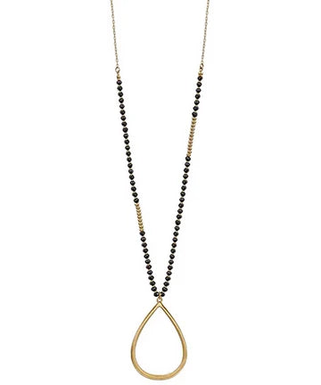 A long gold-tone necklace featuring a beaded strand with alternating sections of small black beads and gold spacer beads, culminating in a large open teardrop pendant.