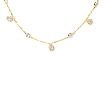 A delicate gold chain necklace featuring multiple small, round pavé-set crystal charms spaced along the chain, displayed against a solid white background.