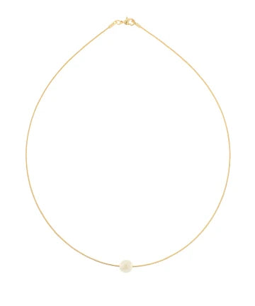 A delicate gold chain necklace with a single small white pearl pendant, displayed against a solid white background.