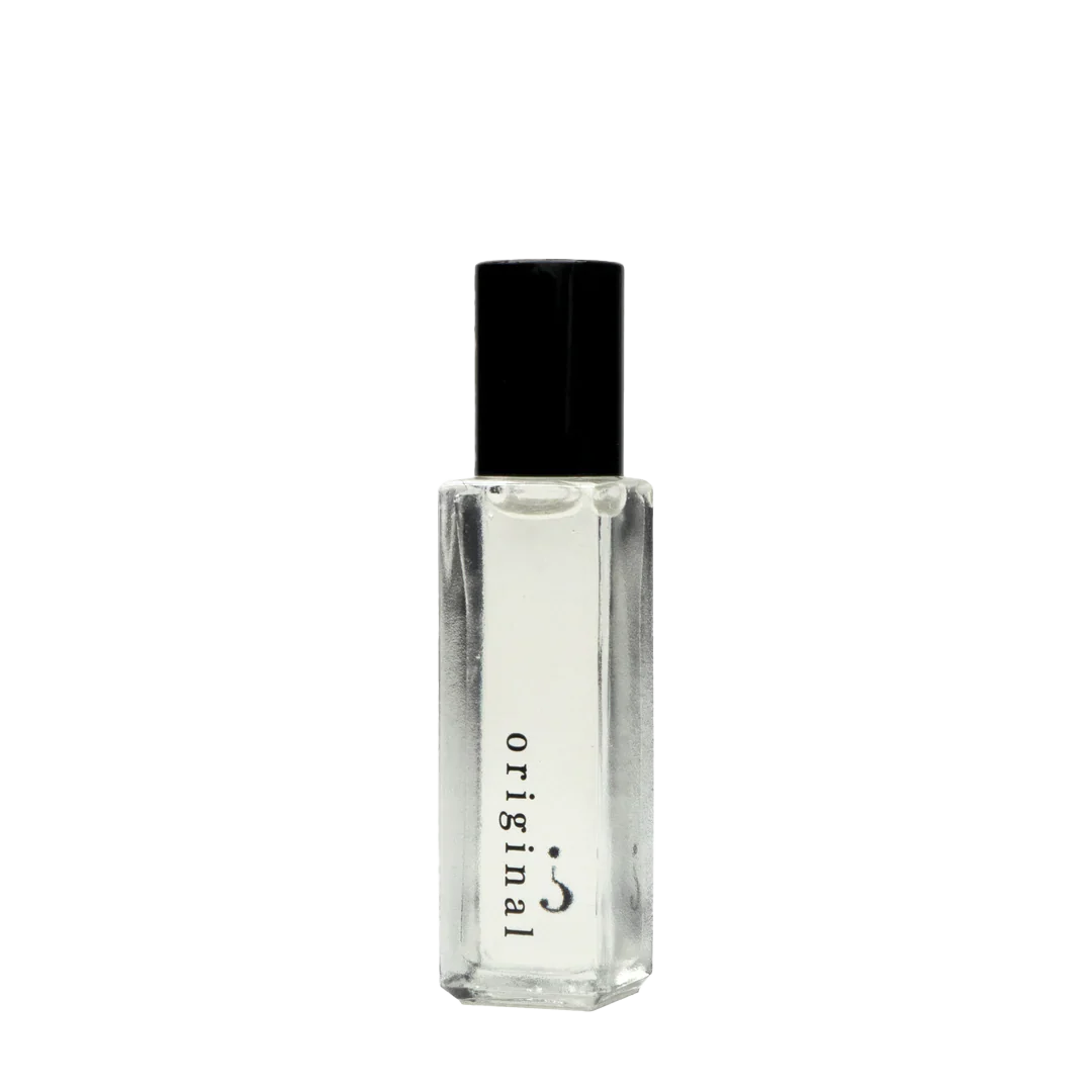 Small clear glass bottle with a black cap on a white background