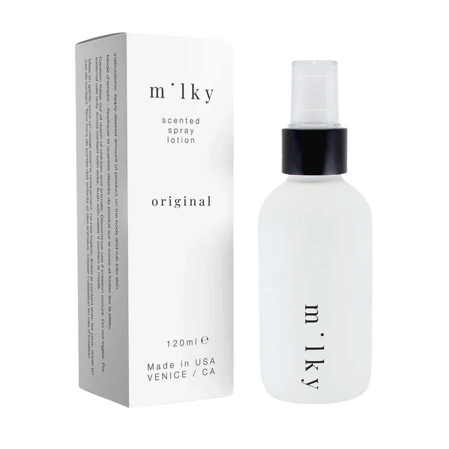 Milky scented spray lotion bottle and packaging on a white background