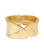 A polished gold cuff bracelet with a unique wavy, sculptural design and a spring-ring clasp, shown on a plain white background.