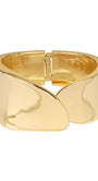 A polished gold cuff bracelet with a unique wavy, sculptural design and a spring-ring clasp, shown on a plain white background.