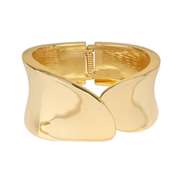 A polished gold cuff bracelet with a unique wavy, sculptural design and a spring-ring clasp, shown on a plain white background.
