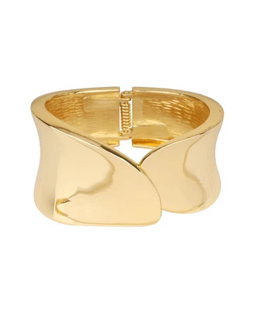 A polished gold cuff bracelet with a unique wavy, sculptural design and a spring-ring clasp, shown on a plain white background.