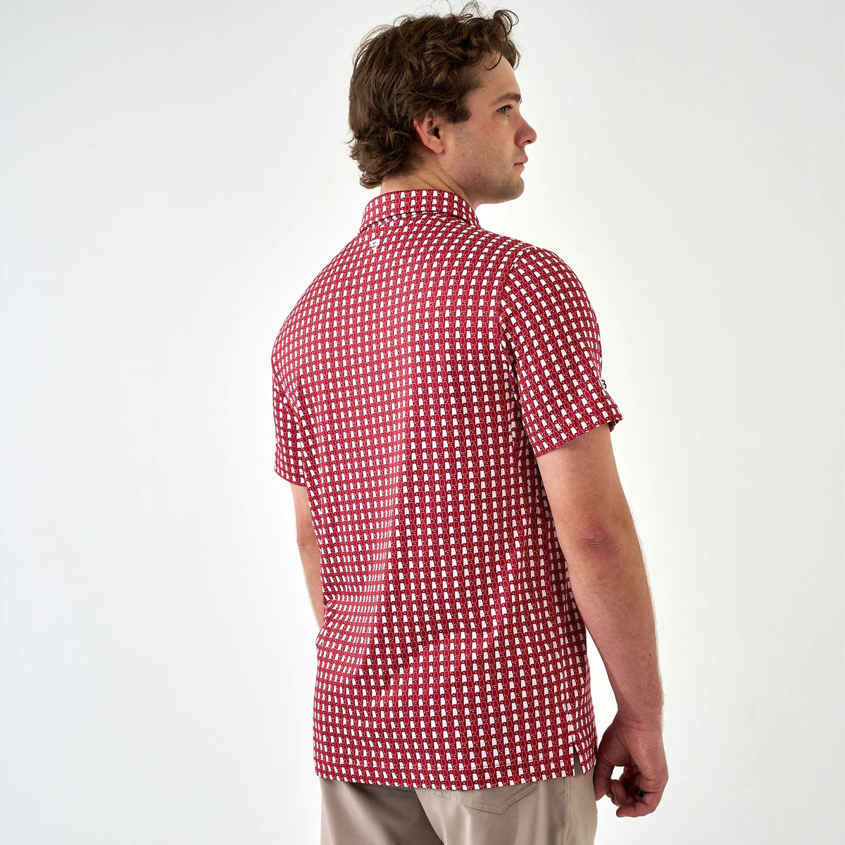 Man wearing a red and white checkered shirt on a white background