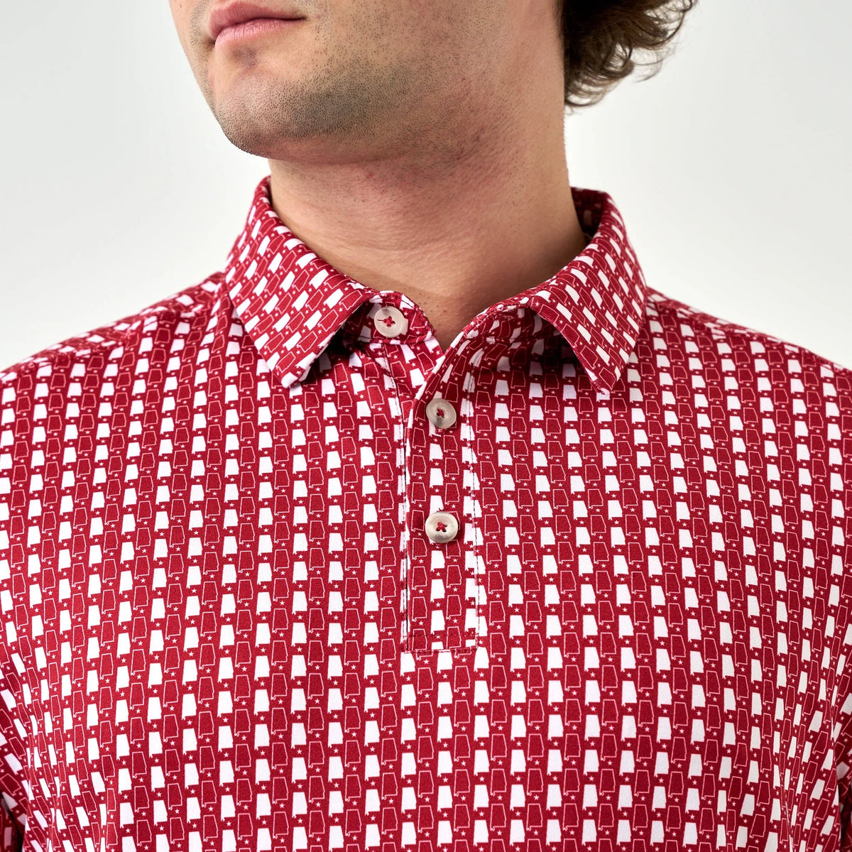 Red patterned shirt worn by a person on a white background
