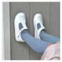 White shoes with blue socks on a wooden floor
