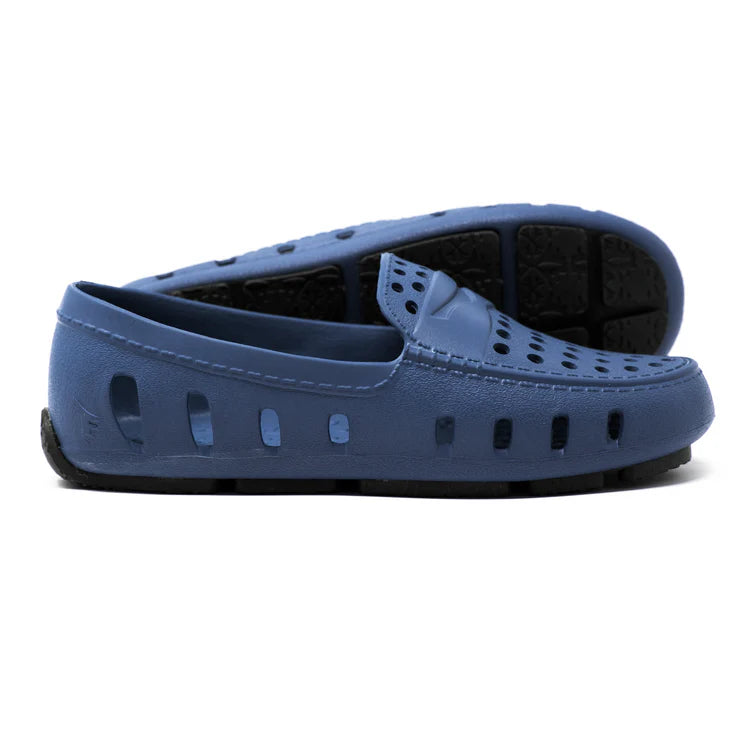 Blue loafers with black soles on a white background