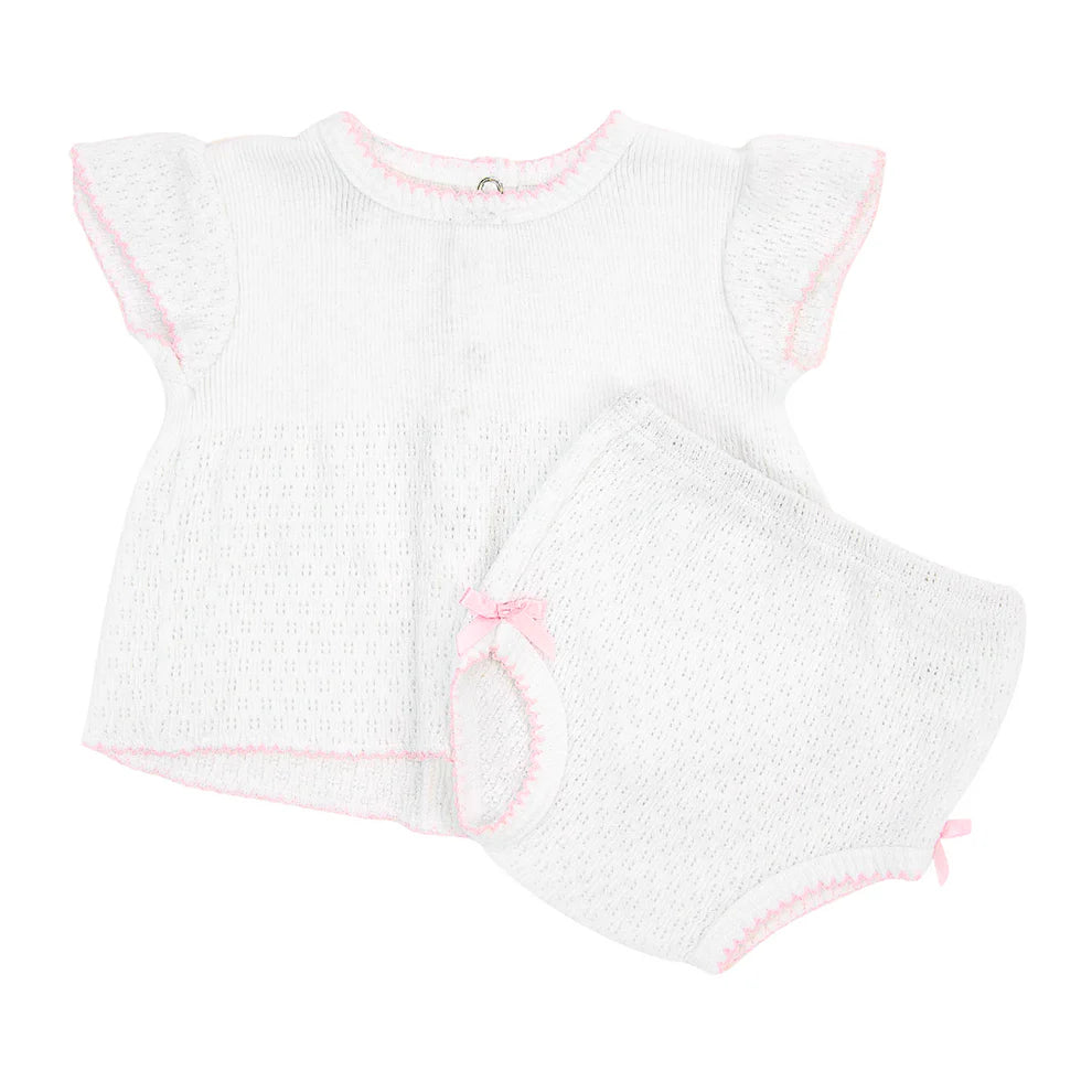 White baby diaper set with pink trim on a white background