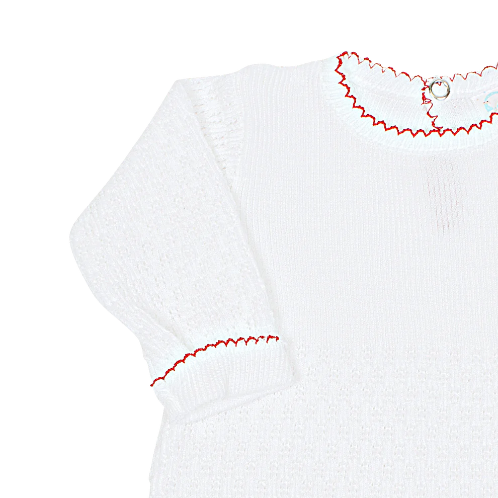 White baby romper with red trim on a white background