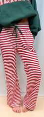 Red and white striped track pants with green drawstring waist and straight legs