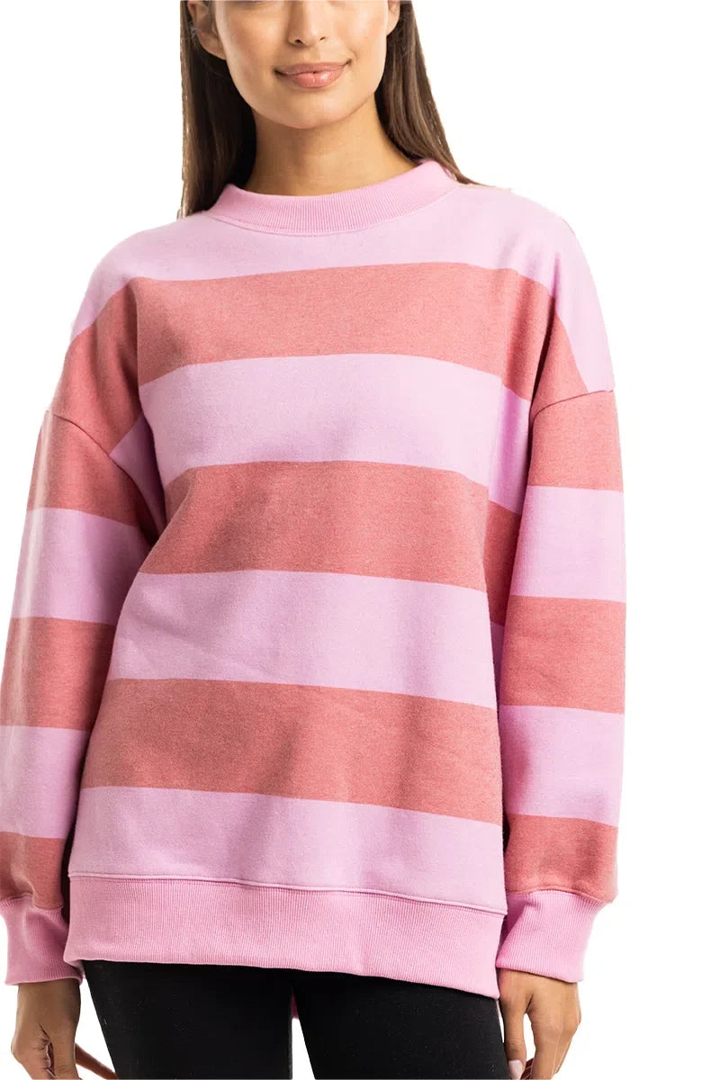 Person wearing a pink and red striped sweater on a white background