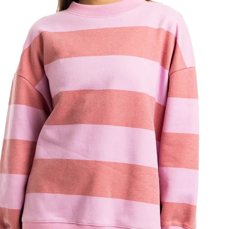 Person wearing a pink and red striped sweater on a white background