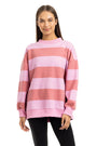 Woman wearing a pink and red striped sweater on a white background