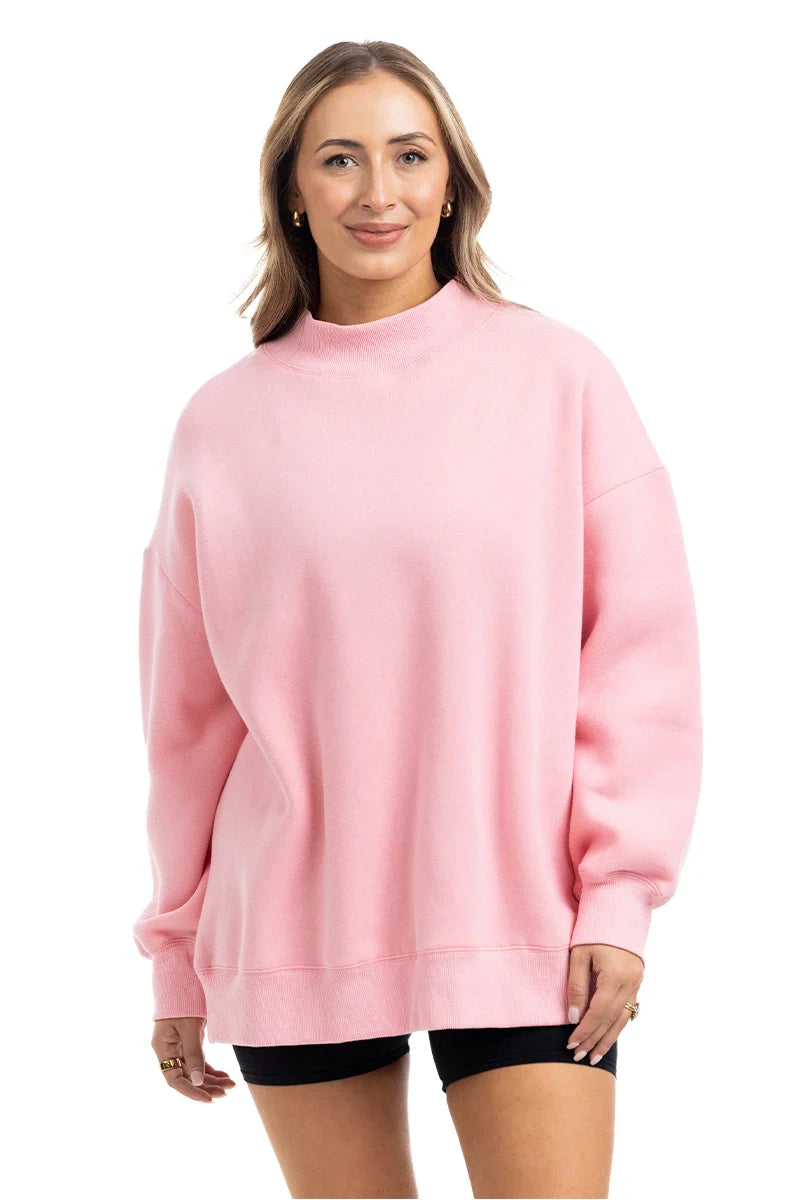 Woman wearing a pink sweatshirt on a white background