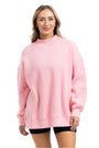 Woman wearing a pink sweatshirt on a white background