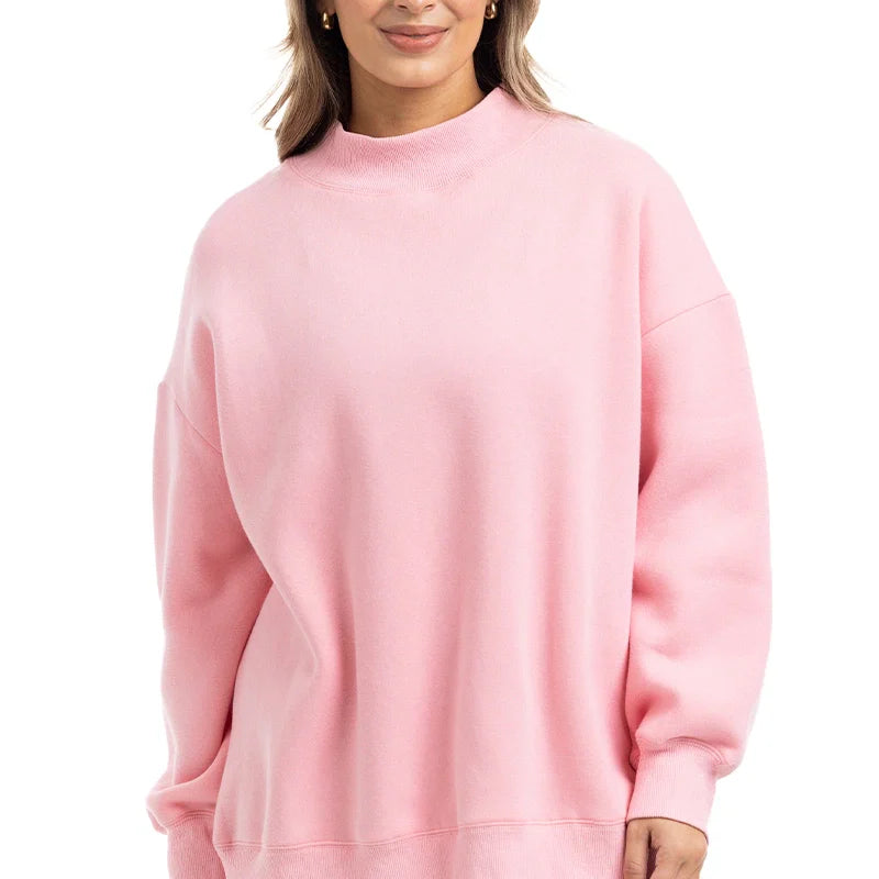 Woman wearing a pink sweatshirt on a white background